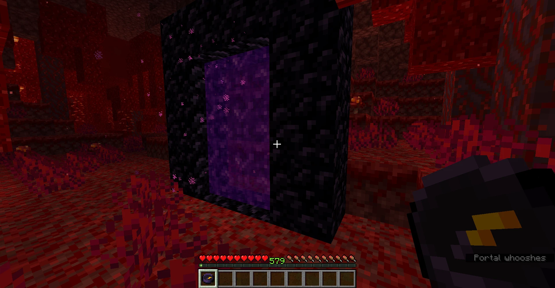 A player with an obsidian compass standing in the nether